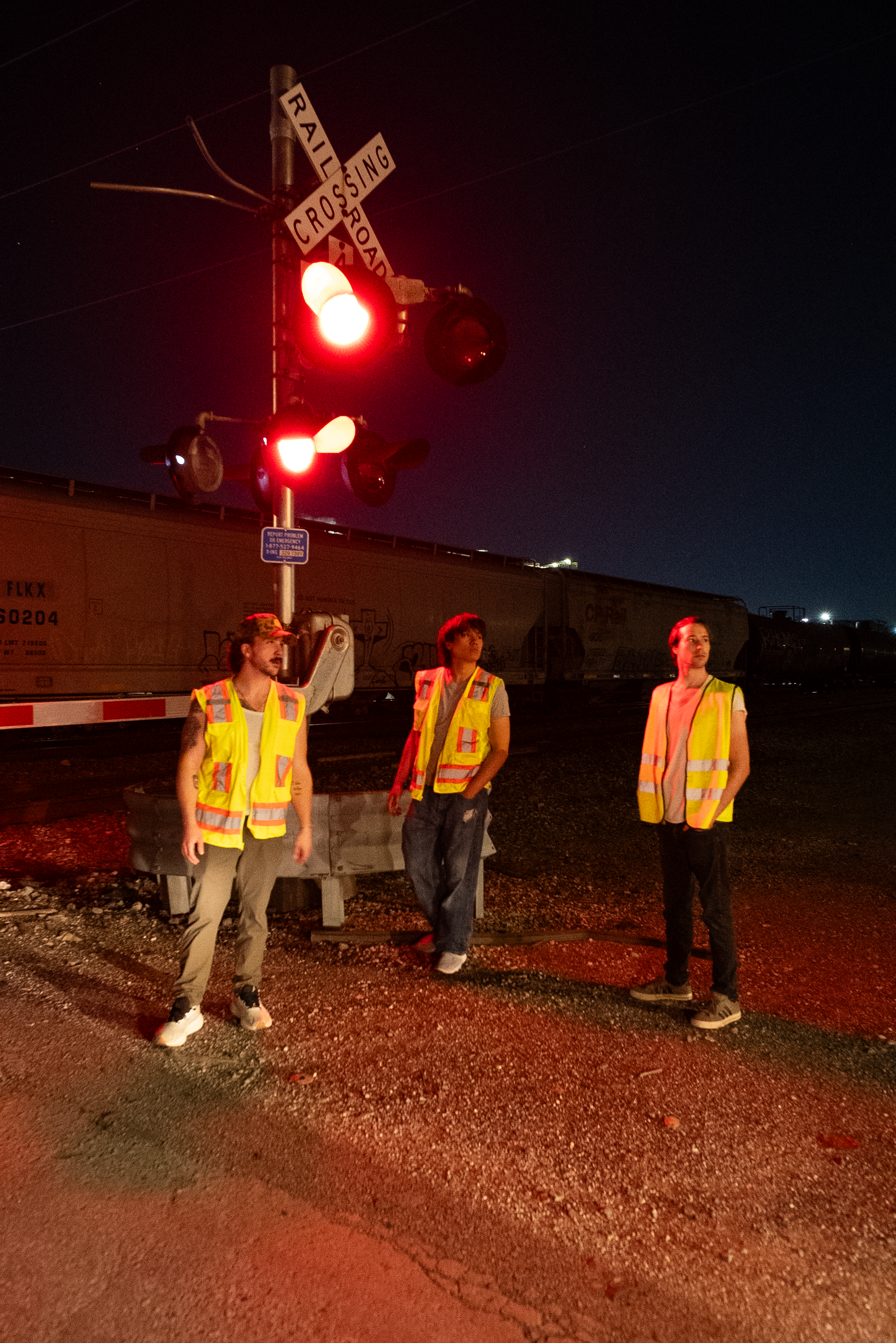 The Thrill of Speed cast beneath a railroad crossing signal