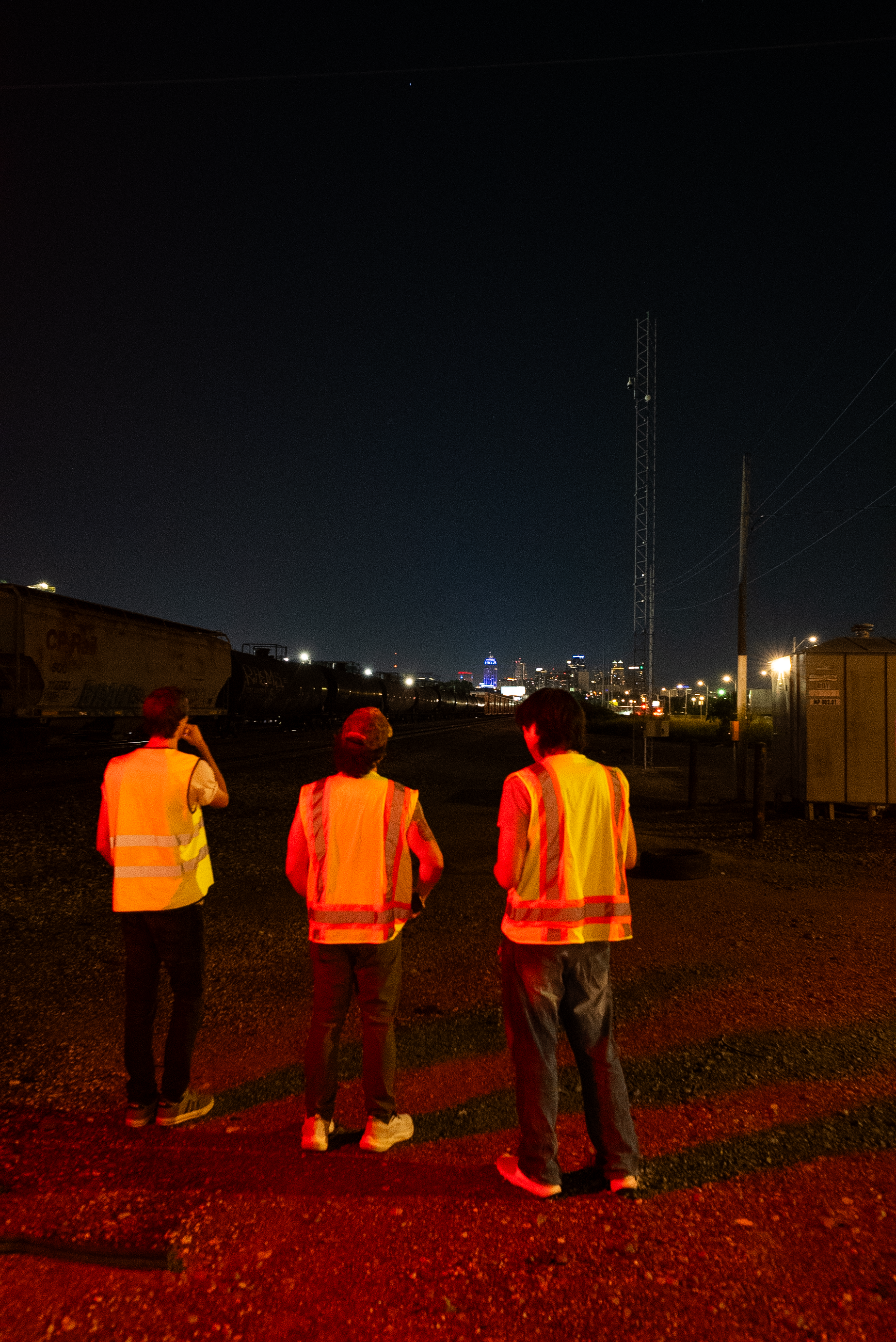 The Thrill of Speed cast looking toward the Kansas City skyline at night