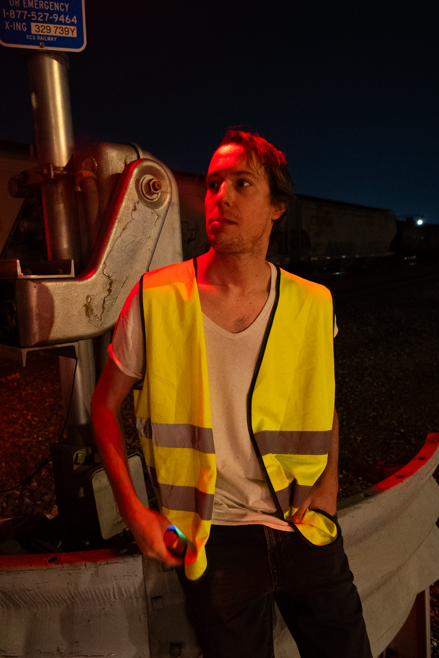 A character from The Thrill of Speed standing near rail crossing equipment