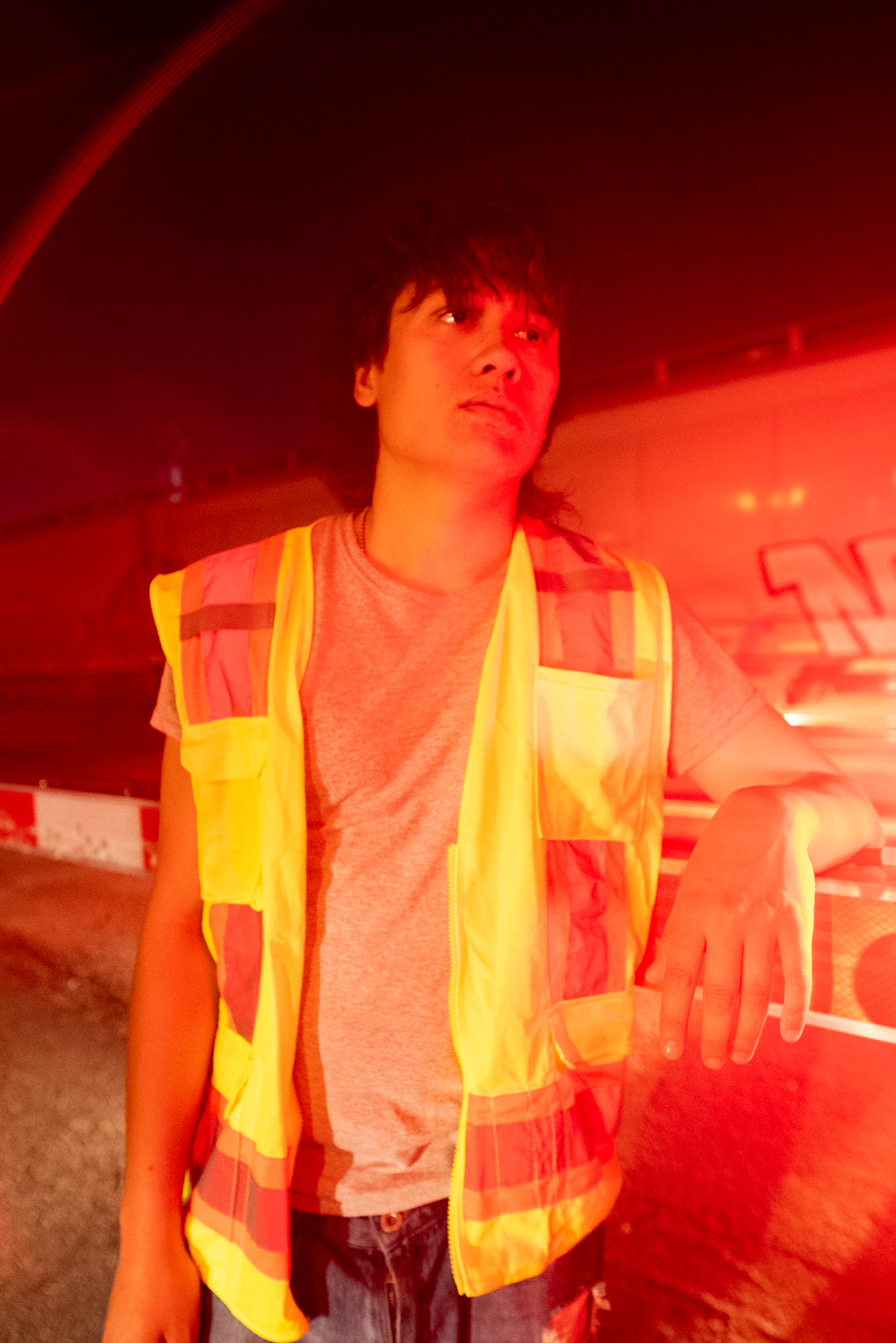 A character from The Thrill of Speed leaning near red rail crossing light