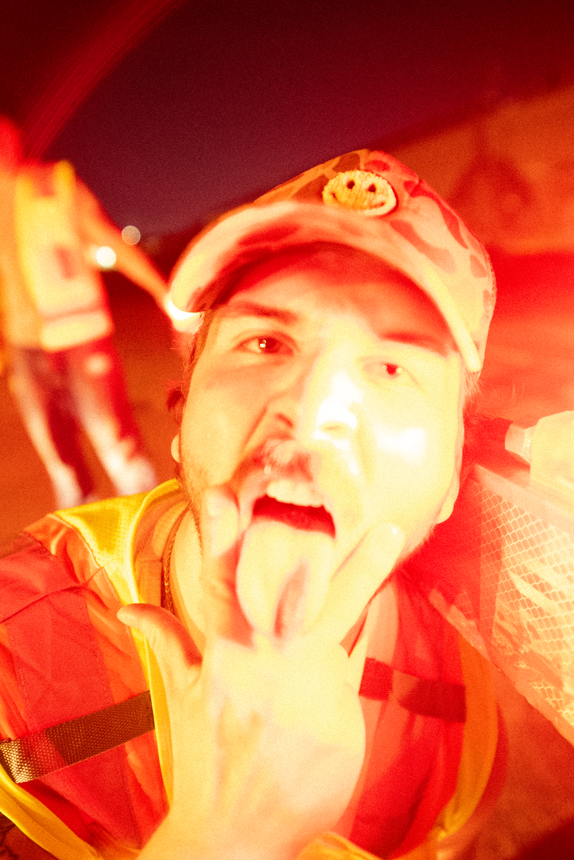 A close portrait from The Thrill of Speed lit by red light