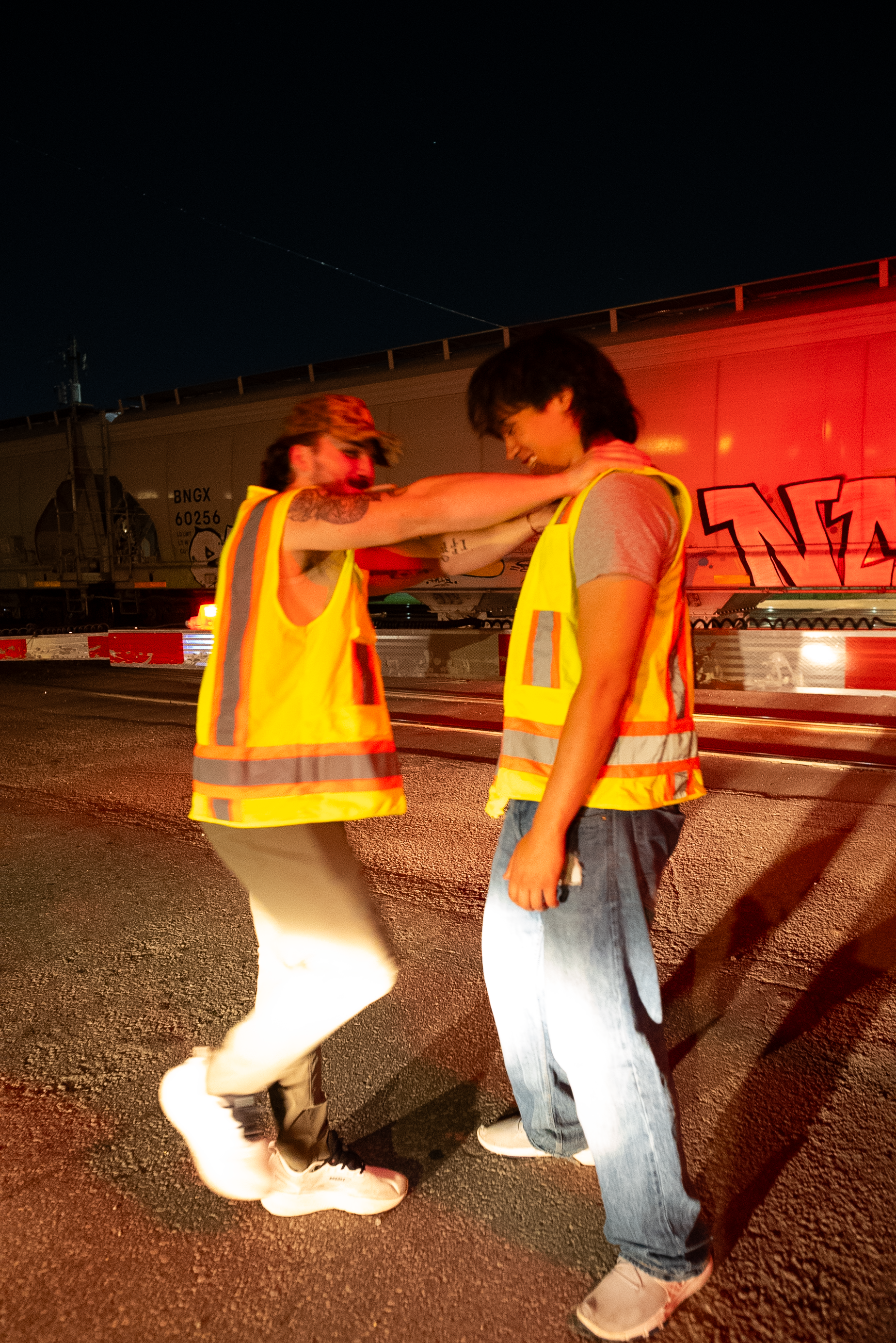Two characters from The Thrill of Speed beside red train crossing lights