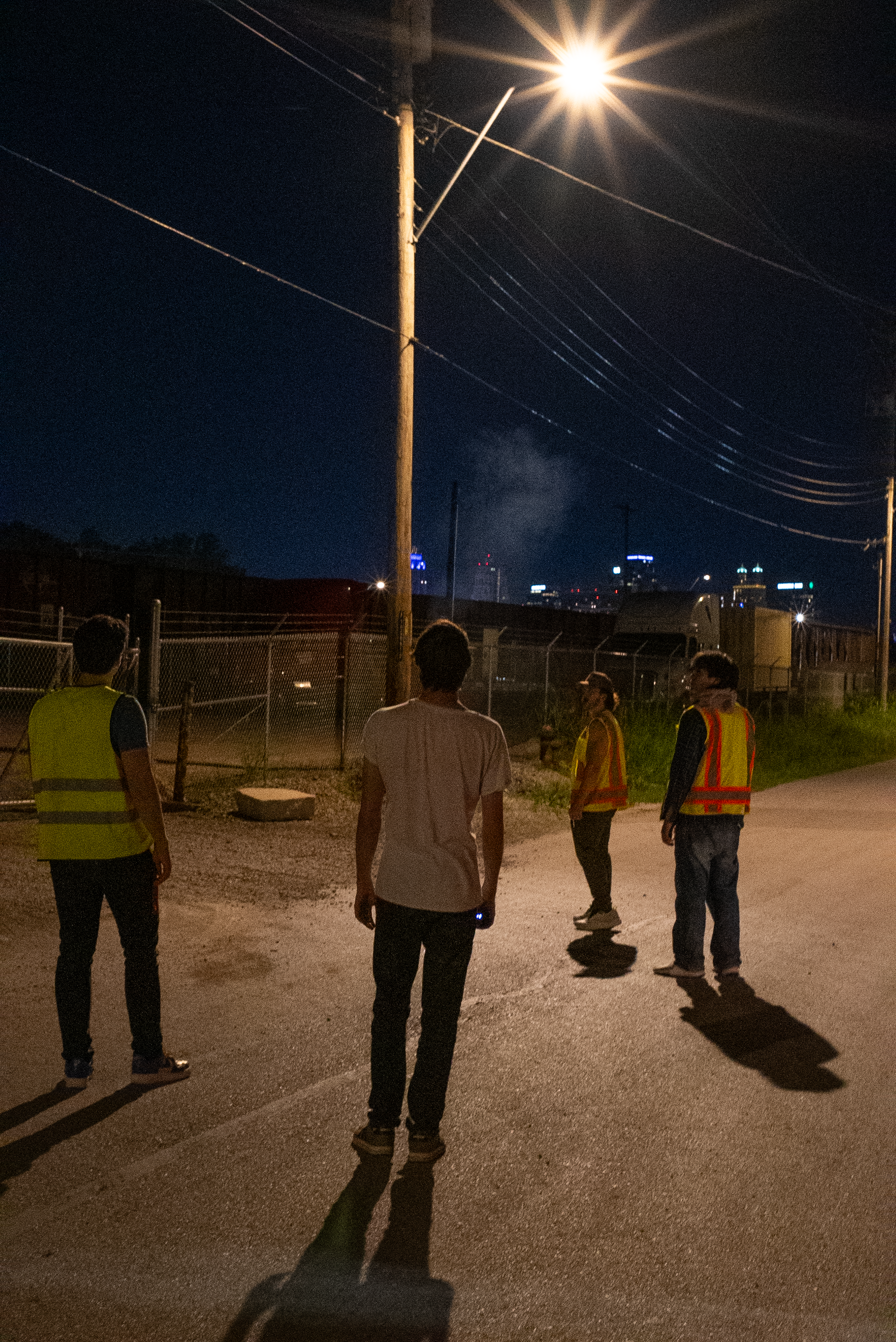 The Thrill of Speed cast standing under a streetlight at night